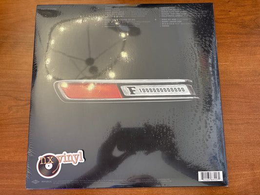 Vinyl record packaging with 'nx vinyl' branding on a wooden surface