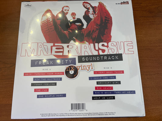 Vinyl record cover with album art and text on a wooden surface