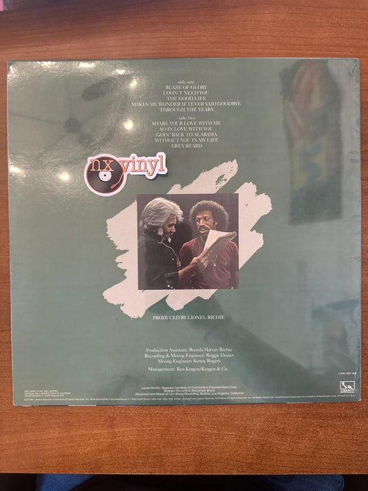 Vinyl record cover with text and images on a wooden surface