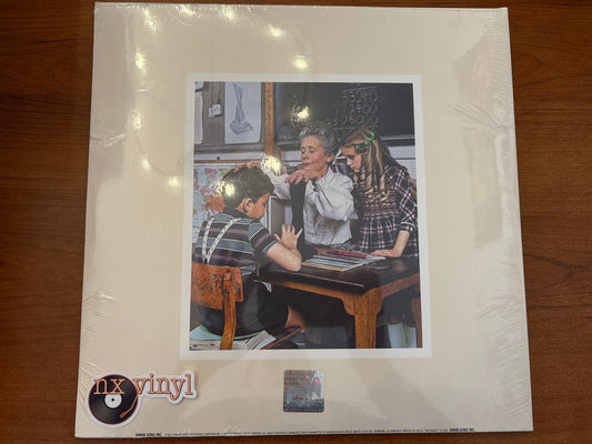 Vinyl record cover with a scene of people around a desk on a wooden surface