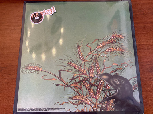 Vinyl record cover with a crow and wheat design on a green background