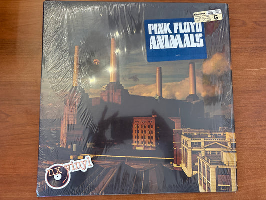 Pink Floyd 'Animals' album cover on a wooden surface