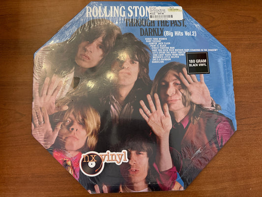 Vinyl record packaging with band members on a wooden surface