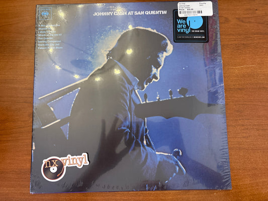 Vinyl record cover with a silhouette of a person playing guitar on a wooden surface