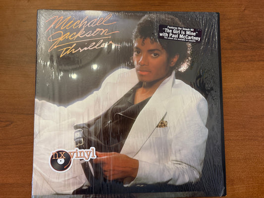 Sealed vinyl record cover of Michael Jackson's 'Thriller' featuring Michael Jackson holding a microphone.