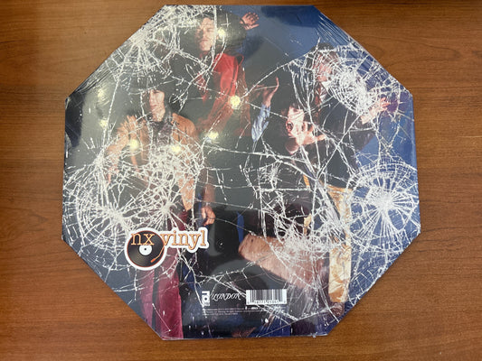 Vinyl record with spider web design on a wooden surface