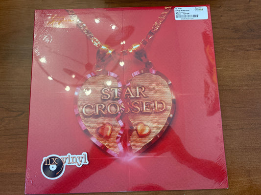 Vinyl record with 'Star Crossed' heart-shaped pendant on red cover