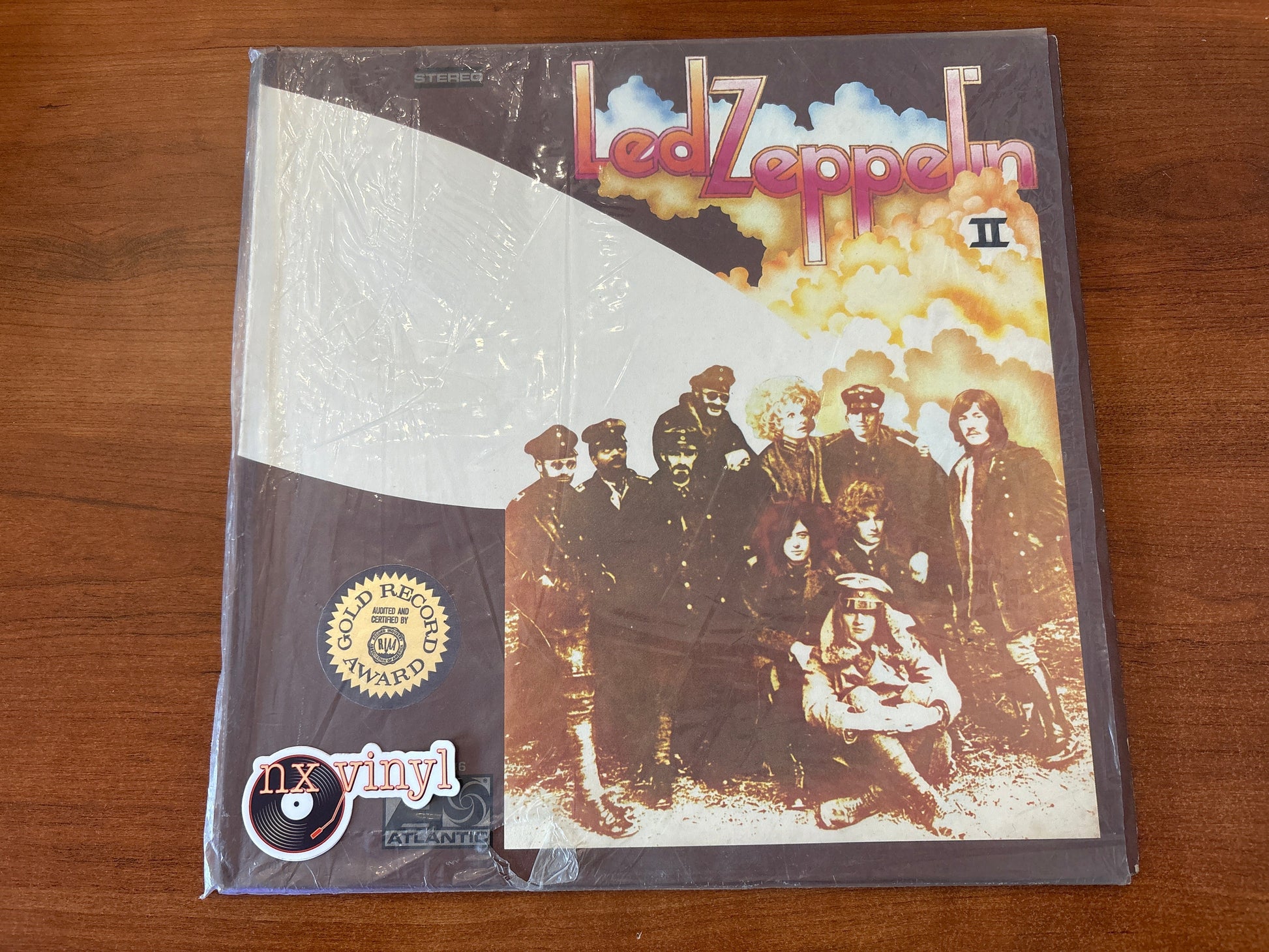 Vinyl record cover with Led Zeppelin image on a wooden surface