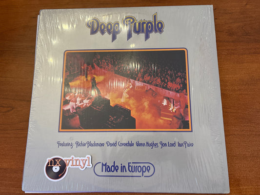 Vinyl record cover for Deep Purple album on a wooden surface