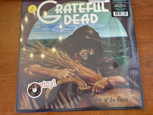 Vinyl record cover for 'Grateful Dead' album on a wooden surface