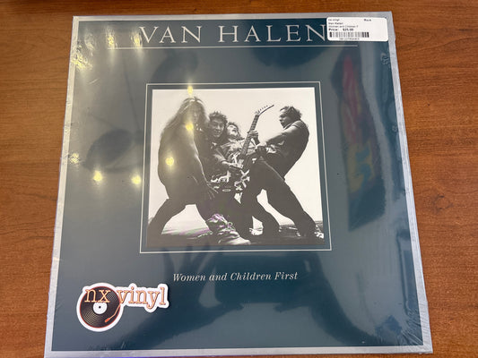 Van Halen 'Women and Children First' vinyl record cover on a wooden surface