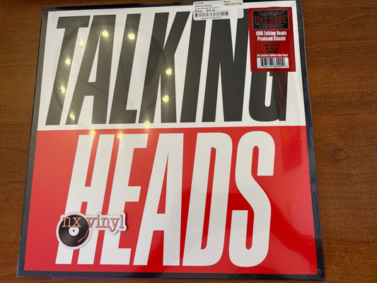 Vinyl record cover for Talking Heads on a wooden surface