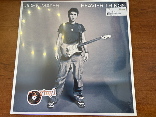 Album cover of 'Heavier Things' by John Mayer with a person holding a guitar.