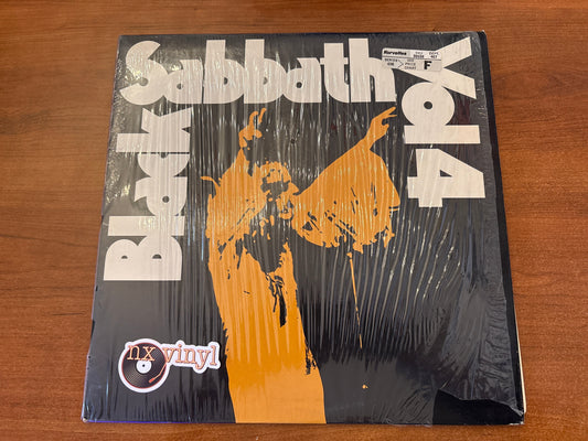 Vinyl record cover for Black Sabbath album on a wooden surface