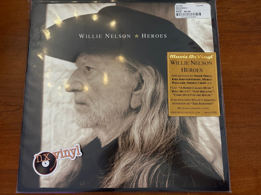 Vinyl record cover with Willie Nelson's face and album details on a wooden surface