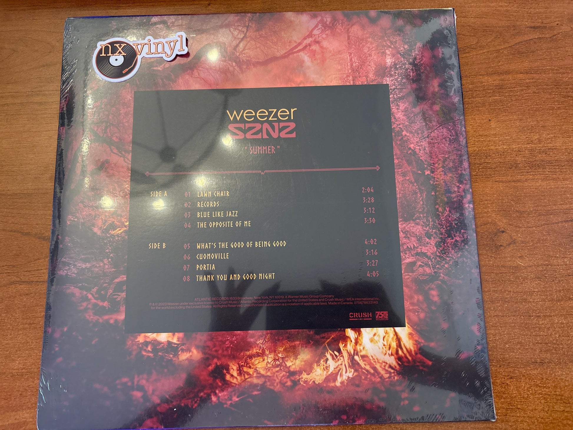 Weezer vinyl record with album cover and tracklist on a wooden surface