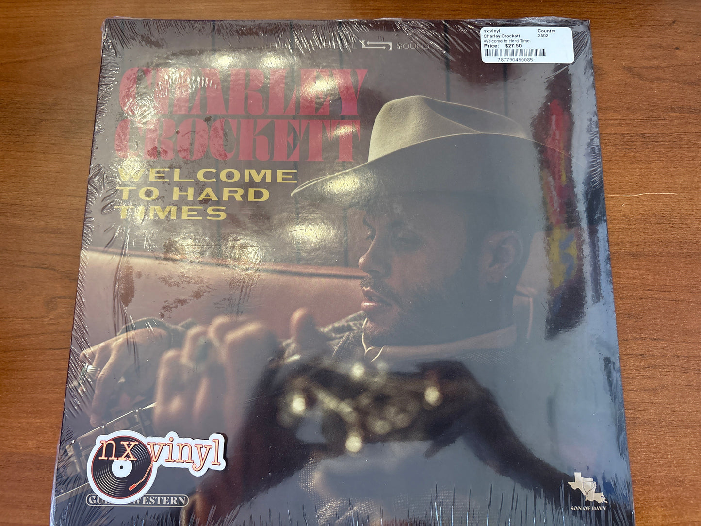 Vinyl record cover with a person wearing a hat and sunglasses, featuring text 'Cowboy Mouth' and 'Welcome to Hard Times'.
